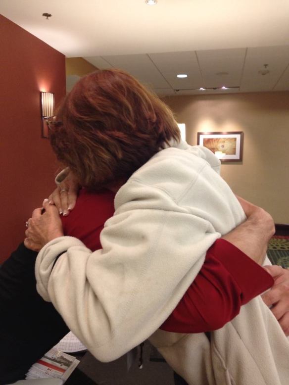 Crew member Linda Zipko hugs a new friend, who wore a red shirt for Red Dress Day, BRAKING AIDS® Ride, September 2013.